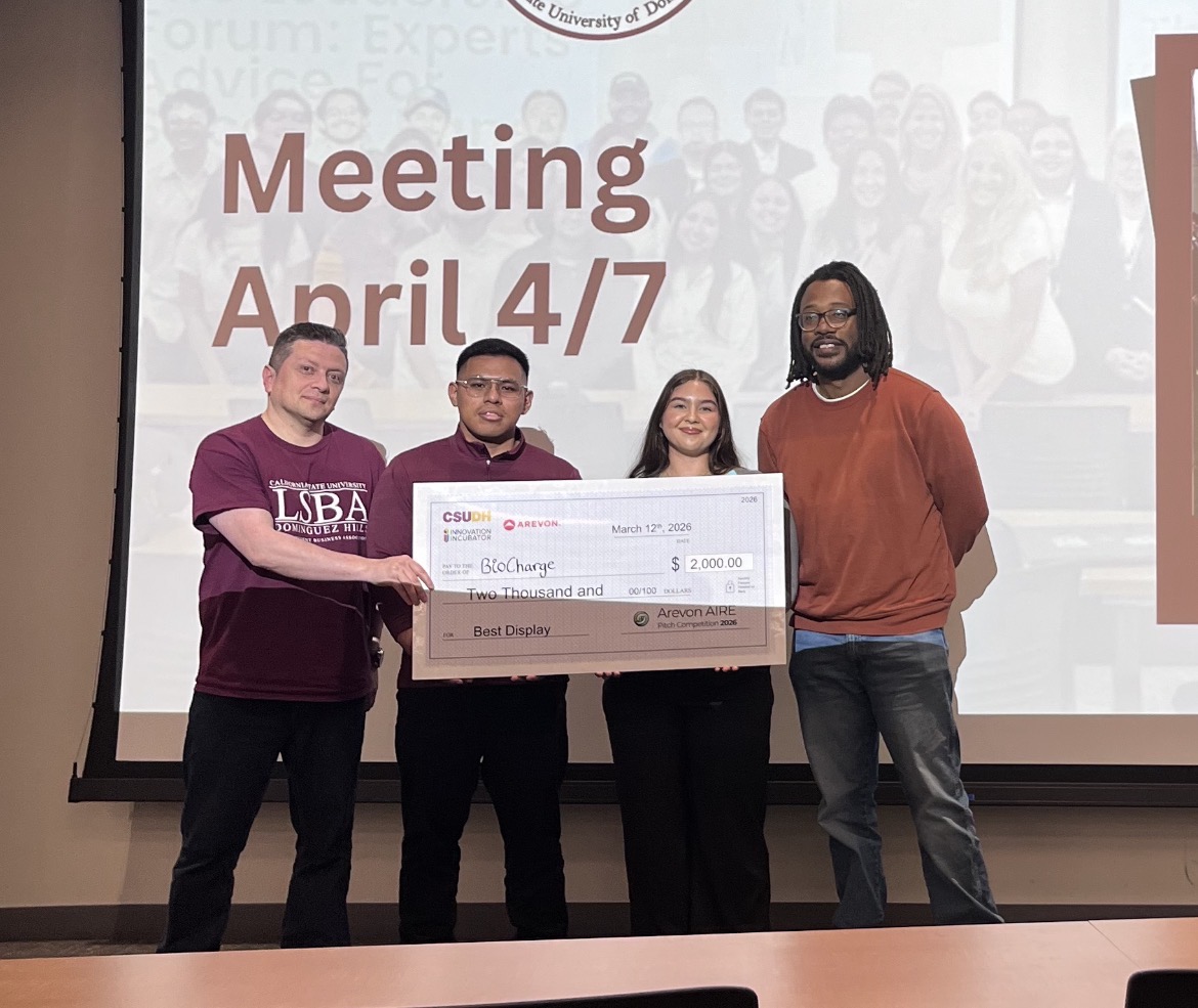 LSBA members holding a large ceremonial check for $2,000 awarded to the student team BioCharge at the pitch competition.